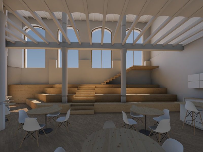 Sala diàfana amb una grada de fusta per seure, taules rodones amb cadires al davant i finestrals alts al fons.